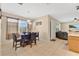 Cozy dining area with a wooden table, four chairs, and a view into the bright living room at 3125 Grasmere View Pkwy, Kissimmee, FL 34746