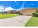Charming one-story home featuring a two-car garage, screened patio, and a spacious driveway at 3125 Grasmere View Pkwy, Kissimmee, FL 34746