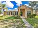 Inviting single-story home featuring a well-manicured lawn, covered entryway, and classic window shutters at 3125 Grasmere View Pkwy, Kissimmee, FL 34746