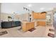 Open-concept kitchen featuring bright countertops and wood cabinets, seamlessly flowing into the living area at 3125 Grasmere View Pkwy, Kissimmee, FL 34746