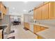 Modern kitchen featuring stainless steel appliances, wood cabinetry, and an adjacent dining area at 3125 Grasmere View Pkwy, Kissimmee, FL 34746
