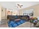 Spacious living area with a large sectional, ceiling fan, and view into the open kitchen at 3125 Grasmere View Pkwy, Kissimmee, FL 34746