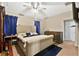 Serene main bedroom featuring a plush bed, dresser, and soft blue accents at 3125 Grasmere View Pkwy, Kissimmee, FL 34746