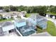 Scenic aerial view of the property showcasing the home's setting near a tranquil pond at 336 Hollingshead Loop, Davenport, FL 33896