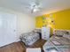 Well-lit bedroom with two beds, modern decor, and white door creating a comfortable retreat at 336 Hollingshead Loop, Davenport, FL 33896