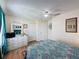 Comfortable bedroom showcasing wood floors, white dresser, and large mirror for getting ready at 336 Hollingshead Loop, Davenport, FL 33896