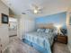 Bedroom with ensuite bathroom, closet, ceiling fan, and laminate flooring at 336 Hollingshead Loop, Davenport, FL 33896