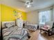 Inviting bedroom with two beds, modern decor, and a large window, creating a comfortable retreat at 336 Hollingshead Loop, Davenport, FL 33896