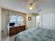 Bedroom with laminate flooring, dresser, window, and ensuite bathroom at 336 Hollingshead Loop, Davenport, FL 33896