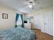 Bright bedroom featuring white trim, a ceiling fan, and light-colored walls and hardwood floors at 336 Hollingshead Loop, Davenport, FL 33896