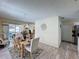 Cozy dining room features a stylish table setting, wood-look floors, and easy access to the outdoor patio at 336 Hollingshead Loop, Davenport, FL 33896