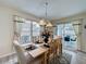 Bright dining area showcasing a wooden table with seating for six, with sliding doors to outside views at 336 Hollingshead Loop, Davenport, FL 33896