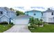 Beautifully landscaped two-story home with a two-car garage and vibrant curb appeal at 336 Hollingshead Loop, Davenport, FL 33896