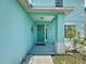 Inviting front entrance featuring an attractive teal front door, a decorative wreath, and stylish wall decor at 336 Hollingshead Loop, Davenport, FL 33896
