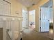 Upstairs hallway with carpet flooring, white railing, and views of the bedrooms at 336 Hollingshead Loop, Davenport, FL 33896
