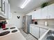 Efficient kitchen with white cabinets, stainless steel refrigerator, and modern appliances at 336 Hollingshead Loop, Davenport, FL 33896