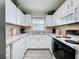 Efficient kitchen features white cabinets, appliances, and countertop space, ideal for cooking and meal preparation at 336 Hollingshead Loop, Davenport, FL 33896