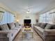 Bright living room with multiple sofas, modern decor, and large windows at 336 Hollingshead Loop, Davenport, FL 33896