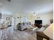 Open-concept living room with modern decor and comfortable seating arrangements at 336 Hollingshead Loop, Davenport, FL 33896