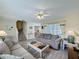 Inviting living room featuring comfortable seating, a ceiling fan, and plenty of natural light at 336 Hollingshead Loop, Davenport, FL 33896