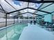 Relaxing screened-in pool area with lounge chairs, perfect for outdoor entertaining and enjoying the Florida sunshine at 336 Hollingshead Loop, Davenport, FL 33896