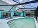 Refreshing screened-in pool with ample lounge space, perfect for outdoor relaxation and entertainment at 336 Hollingshead Loop, Davenport, FL 33896