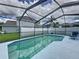 Private screened-in pool with a spacious patio area and scenic backyard at 336 Hollingshead Loop, Davenport, FL 33896