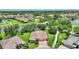 Aerial view of home with terra cotta colored roof, lush landscaping, and long private driveway at 346 Treviso Dr, Kissimmee, FL 34759