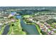 Lovely aerial view of a golf course community by a winding lake at 346 Treviso Dr, Kissimmee, FL 34759