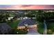 Aerial twilight view of a luxurious home with well-manicured landscaping and beautiful community at 346 Treviso Dr, Kissimmee, FL 34759