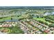 Expansive aerial view of a residential area featuring ponds, golf course, and lush green landscaping at 346 Treviso Dr, Kissimmee, FL 34759