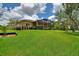 Well-maintained backyard featuring a screened lanai, lush lawn, and landscaped surroundings at 346 Treviso Dr, Kissimmee, FL 34759
