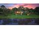 Scenic backyard featuring mature trees, lush greenery, and serene pond views at 346 Treviso Dr, Kissimmee, FL 34759