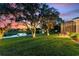 Beautiful backyard view with water feature, mature trees, and lush green lawn at 346 Treviso Dr, Kissimmee, FL 34759