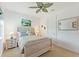Bright bedroom features a decorative ceiling fan, a wooden bed frame and neutral carpet at 346 Treviso Dr, Kissimmee, FL 34759