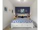 Bedroom with accent wall featuring blue and yellow bedding and decorations at 346 Treviso Dr, Kissimmee, FL 34759