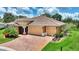 Stunning home exterior with a tile roof, brick driveway and manicured lawn at 346 Treviso Dr, Kissimmee, FL 34759