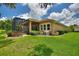 Side view of the house showcasing a screened lanai and well-manicured landscaping at 346 Treviso Dr, Kissimmee, FL 34759