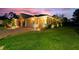 Charming home exterior showcasing a paver driveway, manicured lawn, and lush landscaping at 346 Treviso Dr, Kissimmee, FL 34759