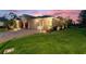 Home exterior with a 3-car garage, well-manicured lawn, and mature landscaping at 346 Treviso Dr, Kissimmee, FL 34759