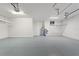 Bright garage featuring epoxy flooring, water heater, and storage shelves at 346 Treviso Dr, Kissimmee, FL 34759