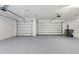 Spacious two car garage with epoxy flooring and two overhead doors at 346 Treviso Dr, Kissimmee, FL 34759