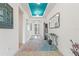 Elegant hallway with tile flooring, unique decor and bright, white walls at 346 Treviso Dr, Kissimmee, FL 34759