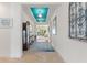 Spacious hallway with tile floors, blue tray ceiling and decorative wall art at 346 Treviso Dr, Kissimmee, FL 34759