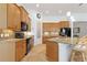 Well lit kitchen with black appliances, a large island, and tile backsplash at 346 Treviso Dr, Kissimmee, FL 34759