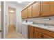 Bright laundry room with washer, dryer, sink, and ample cabinet space for storage and organization at 346 Treviso Dr, Kissimmee, FL 34759