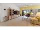 Bright living room with a large entertainment center and access to a screened patio at 346 Treviso Dr, Kissimmee, FL 34759