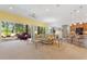 Open-concept living room featuring tile floors, a fan, and access to the kitchen at 346 Treviso Dr, Kissimmee, FL 34759