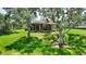 Charming home on lush green lawn with mature trees offering shade to the rear patio at 346 Treviso Dr, Kissimmee, FL 34759