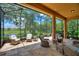 Relaxing screened patio showcasing lake views and comfortable wicker seating arrangements at 346 Treviso Dr, Kissimmee, FL 34759